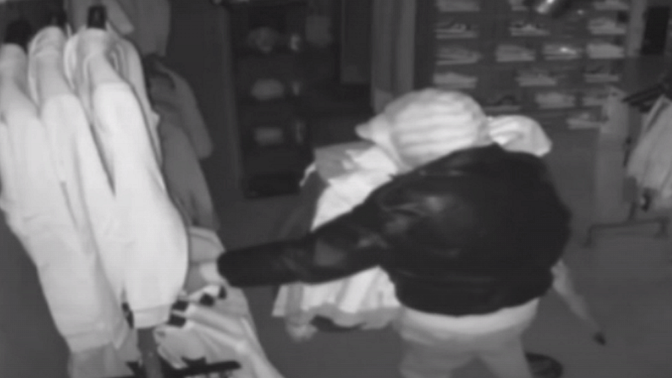 CCTV image of thief taking clothes