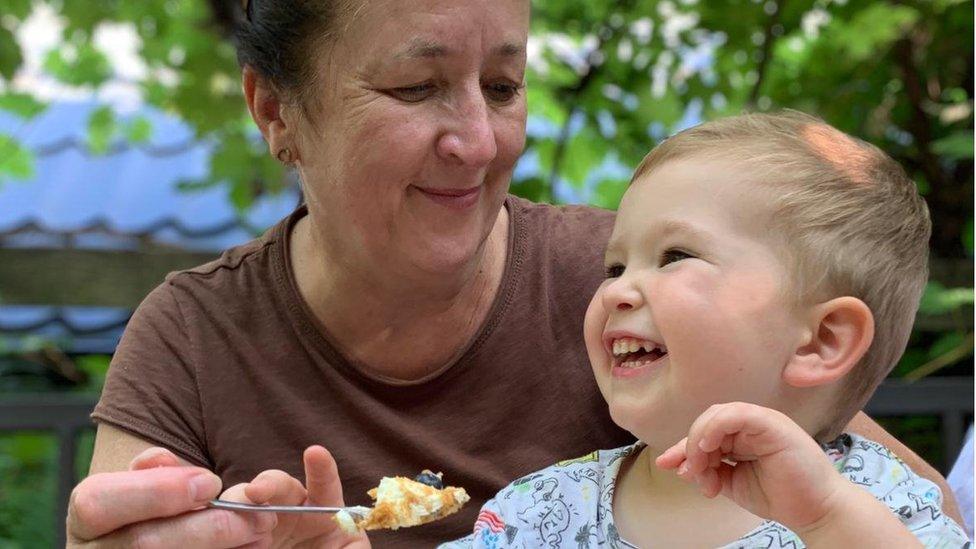 Dorota's mother feeding Dorota's child