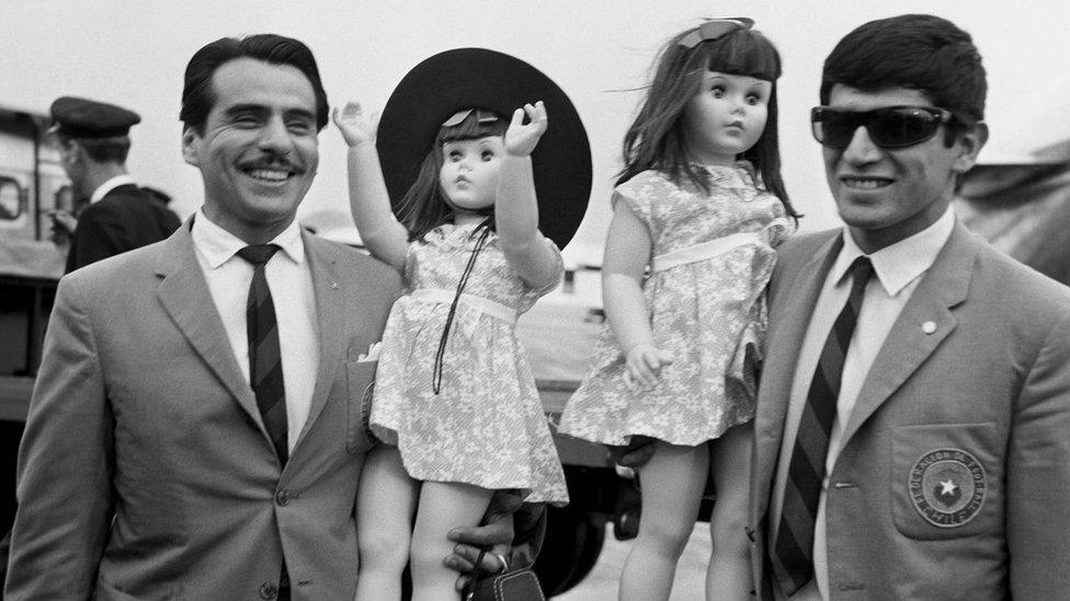 Chile's Pedro Araya and Juan Olivares arrive in England for the 1966 World Cup carrying two giant dolls (5 July 1966)