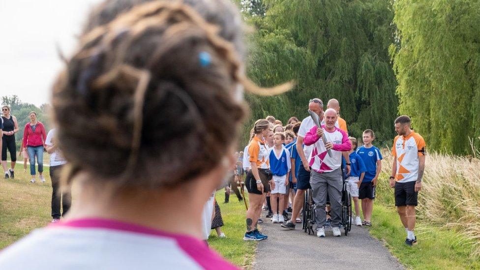 Glyn Bennett takes part in The Queen's Baton Relay as it visits Uttoxeter as part of the Birmingham 2022 Queens Baton Relay on July 20, 2022 in Uttoxeter