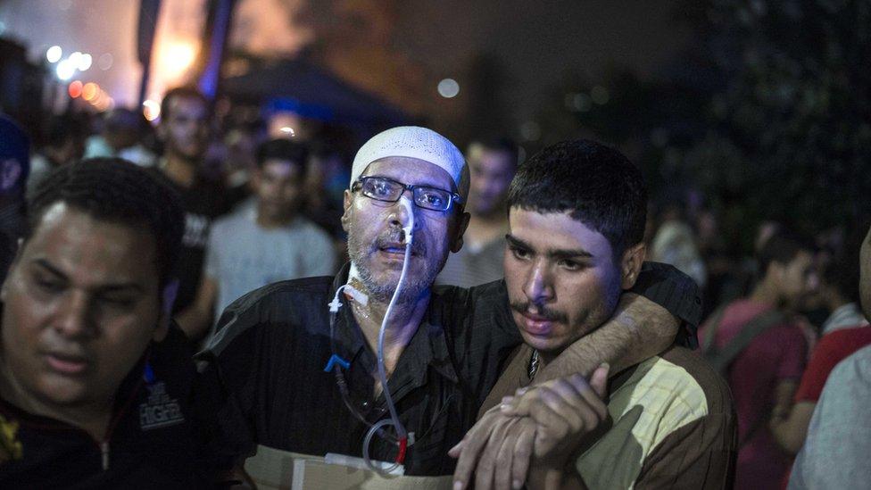 People transport an injured man from a blast inside the National Cancer Institute