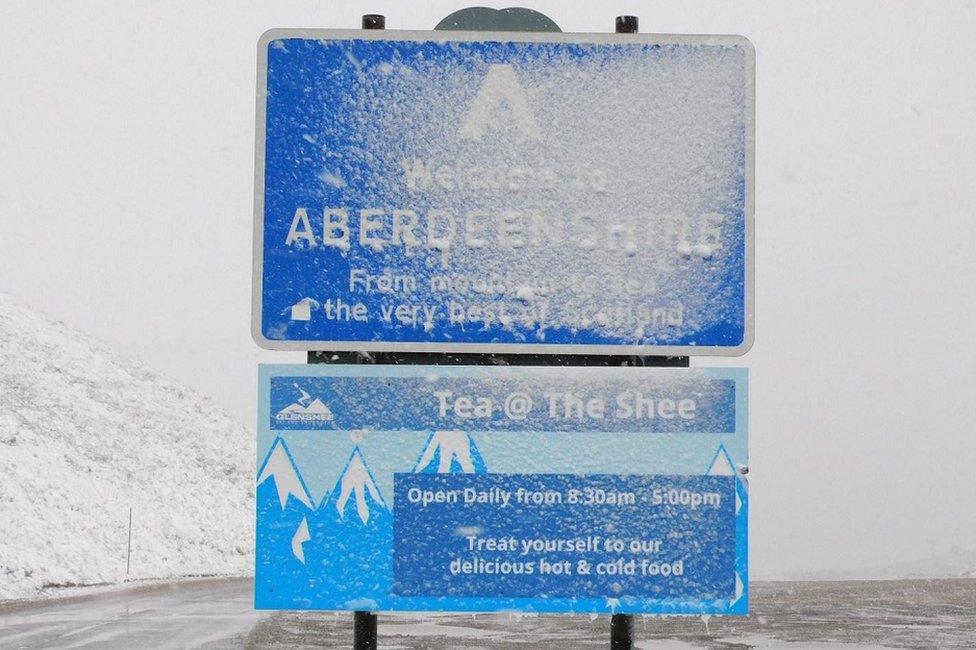 Snow covered road sign