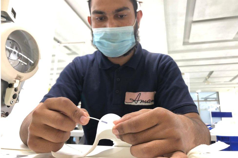 Anwar adds stitching to a bra