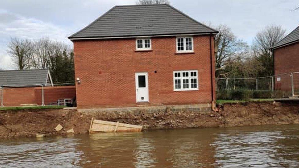 Damaged house by river