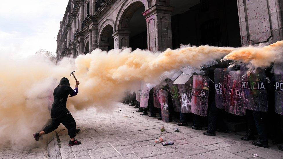 A woman confronts a riot police line during a protest against gender-based violence on International Women's Day, 8 March 2021, in Toluca, Mexico.