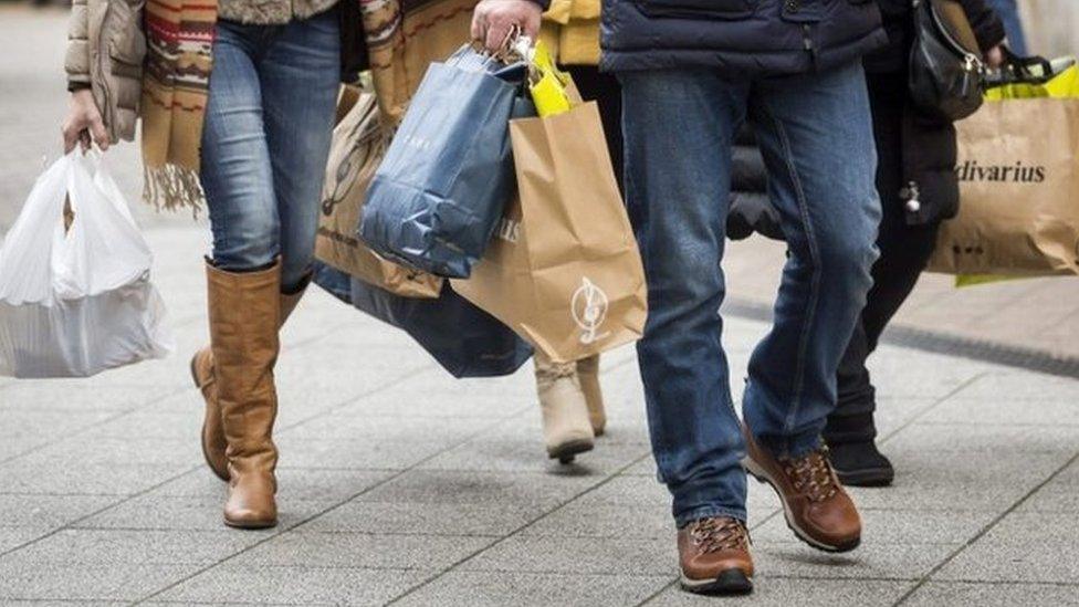 Christmas shoppers carry bags of goods