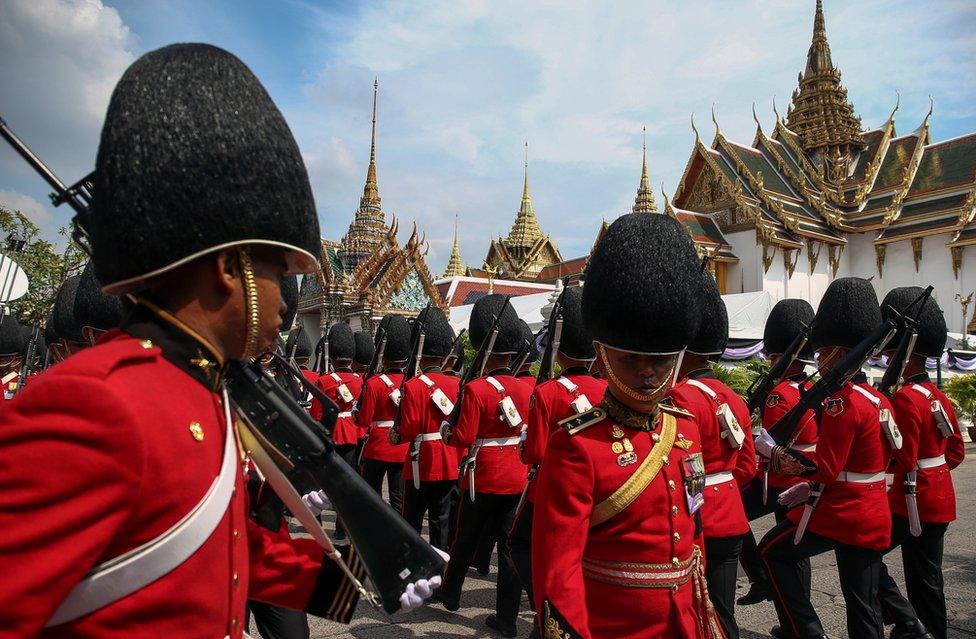 In this picture, Thai Royal guards march as mourners line up to enter the Grand Palace to pay respect to Thailand"s late King Bhumibol Adulyadej in Bangkok