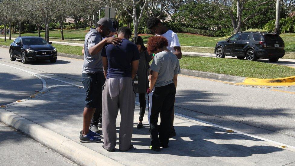 An impromptu prayer on the pavement near the school on Thursday