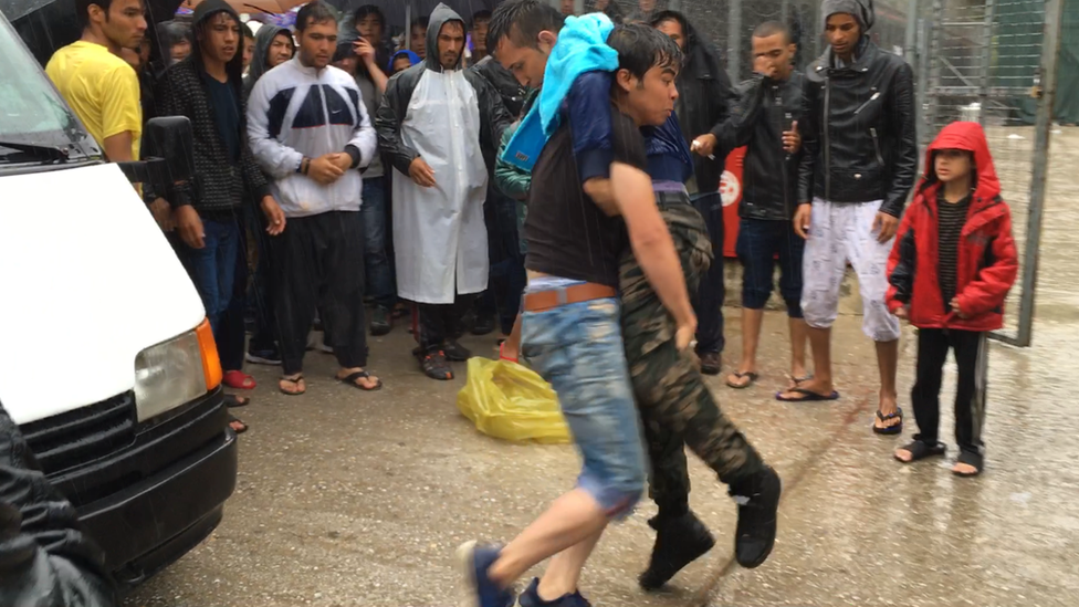 Two people fight at a migrant camp in Samos, Greece