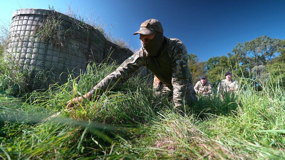 Ukrainian solder on the ground during training