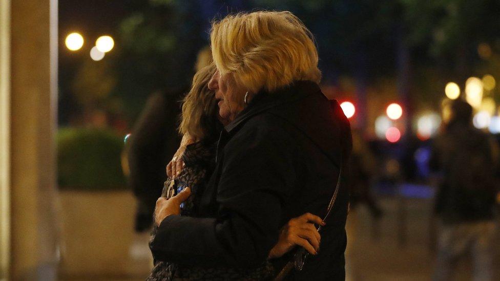 Two women hug each each other after a shooting near the Champs Elysees in Paris, France, 20 April 2017