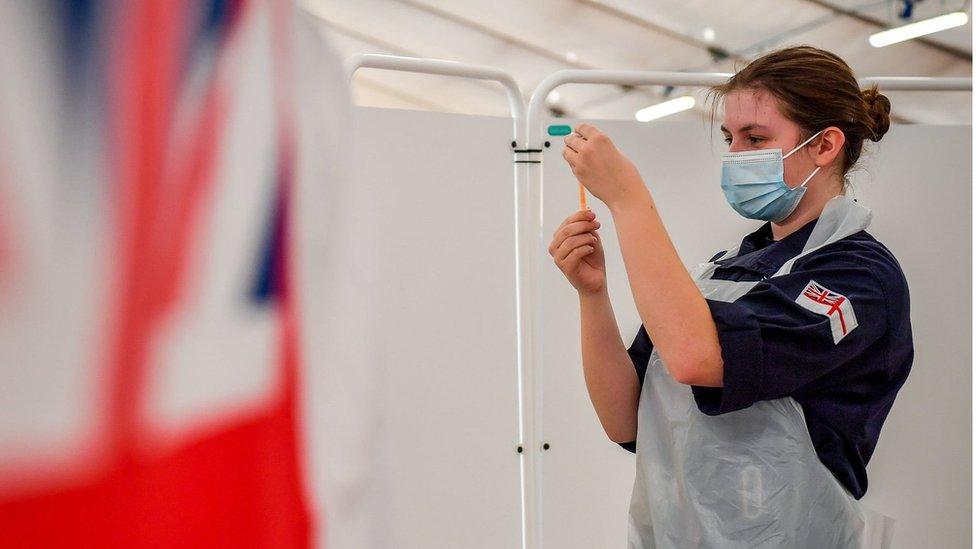 Royal Navy personnel prepare to give vaccines to the public at a coronavirus vaccination centre set up at Bath Racecourse