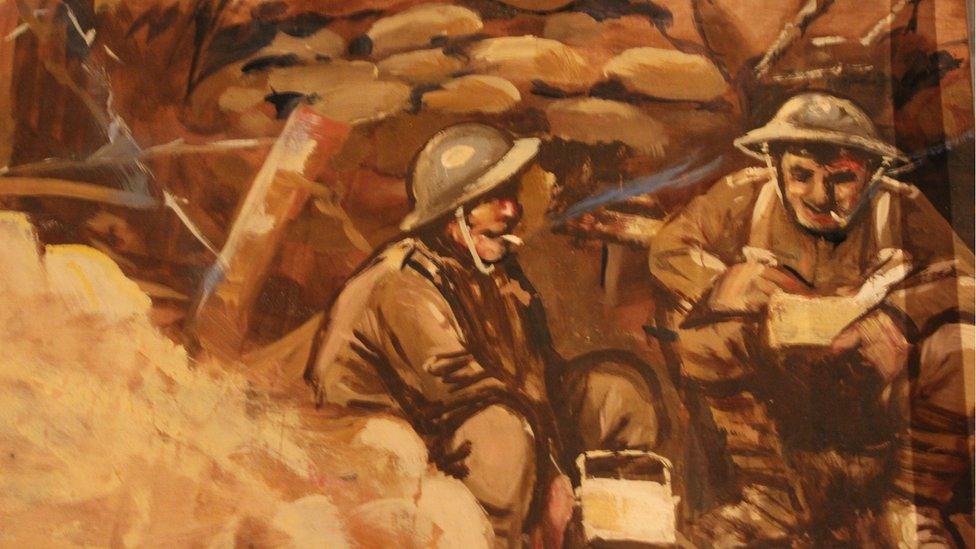 Two soldiers sitting in a trench smoking