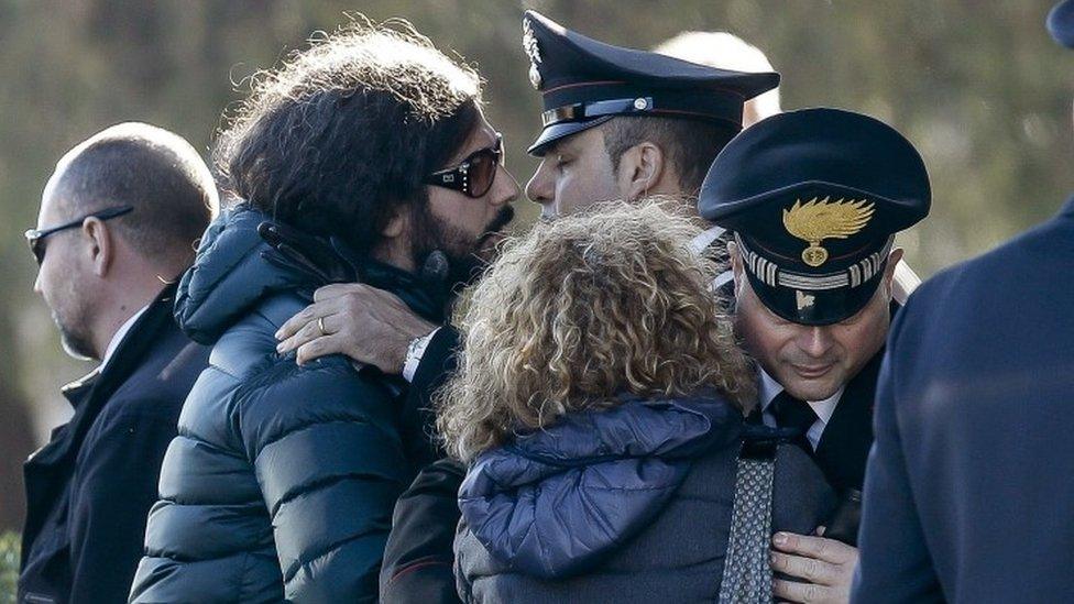 Giovanna Di Agostino, mother of Italian victim Fabrizia Di Lorenzo, and her son Gerardo, left, are hugged by authorities upon their arrival from Berlin with the coffin of her daughter Italian victim Fabrizia Di Lorenzo, at Rome"s military airport of Ciampino, Saturday, Dec. 24, 2016