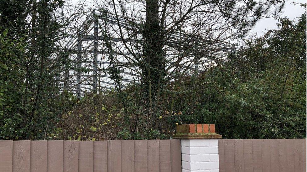 View of a warehouse from a back garden