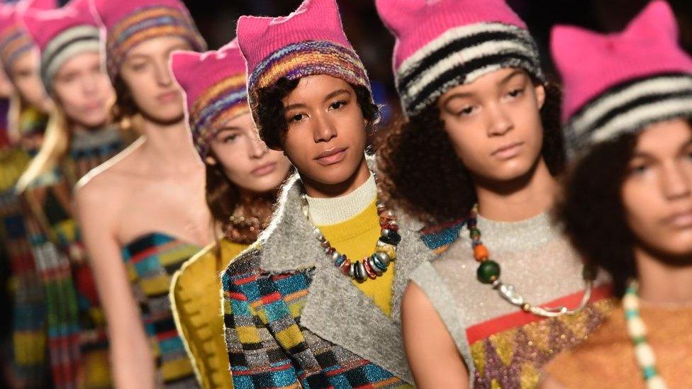 Models wearing pink hats walk the runway at the end of the show for fashion house Missoni during the Women's Fall/Winter 2017/2018 fashion week in Milan, on February 25, 2017.