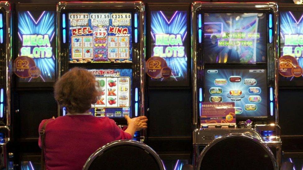 Woman playing bingo gambling machine