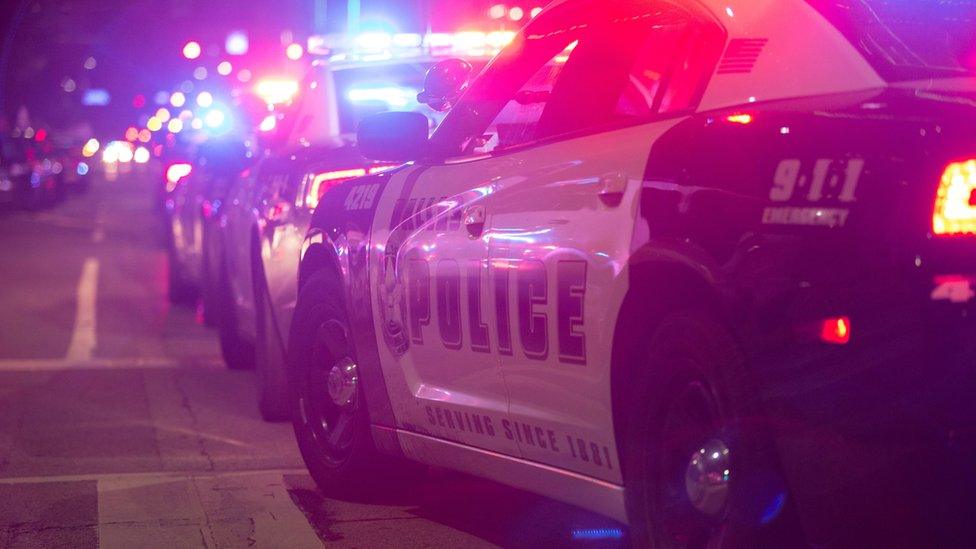 Row of police cars with lights on in Dallas, Texas - July 2016