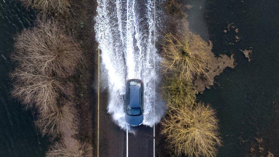 Car driving through flood on A1101 in Norfolk on Sunday