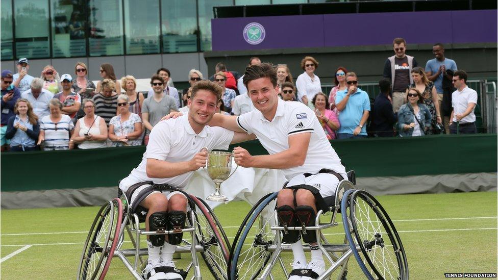 Alfie Hewett and Gordon Reid lifting the men's doubles trophy at Wimbledon