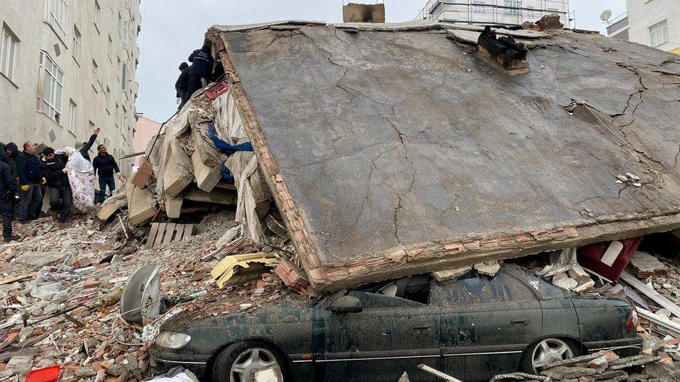 A car buried by the roof of a house