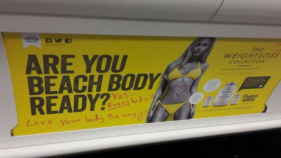 The posters were vandalised after they appeared on London Underground.