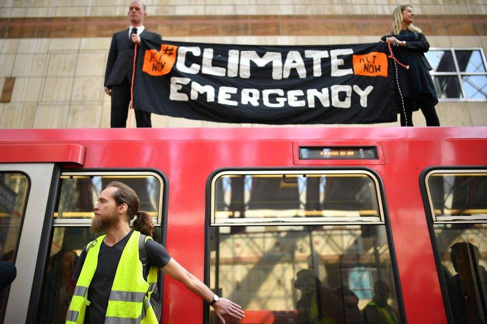 Activists on to a Docklands Light Railway train at Canary Wharf