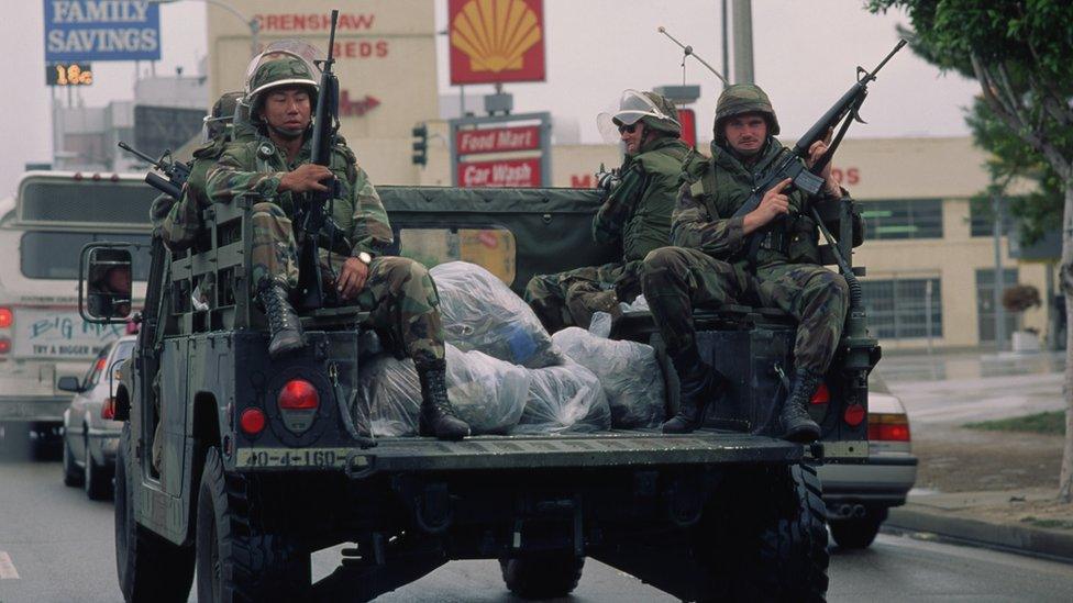 Military troops help restore order in Los Angeles after rioting occurred in the wake of the verdict in the Rodney King case.