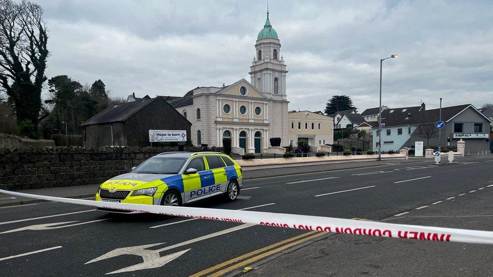 A police car at a cordon outside Whiteabbey Presbyterian Church