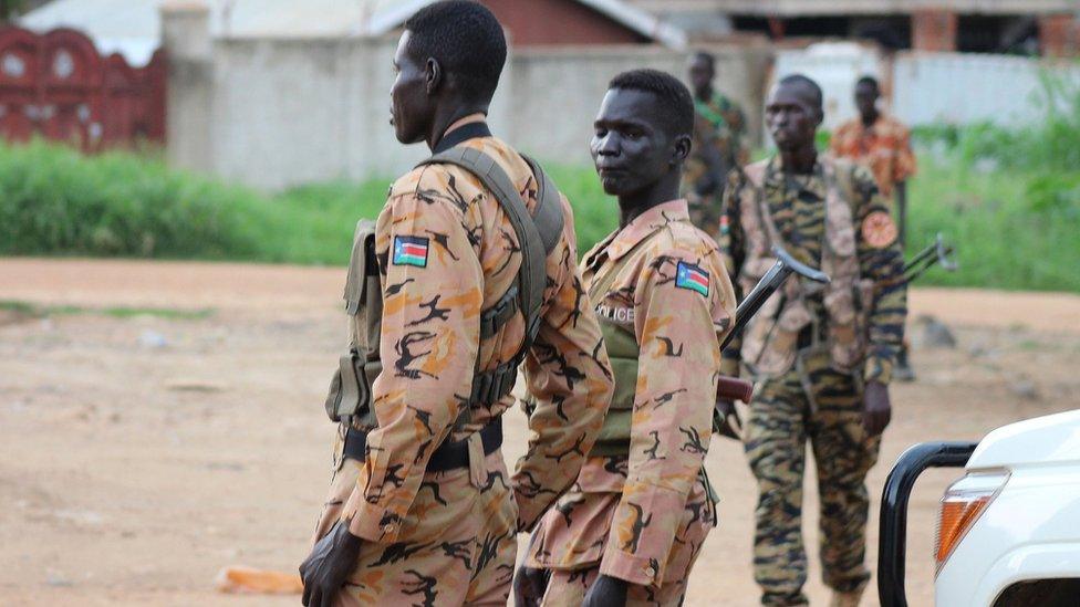 South Sudan police and soldier stand guard on Juba street - 10 July