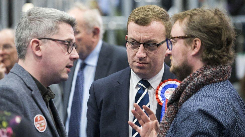 Sinn Fein councillor Niall O Donnghaile, DUP candidate Christopher Stalford and Alliance candidate councillor Emmet McDonough-Brown, at the main Belfast count centre