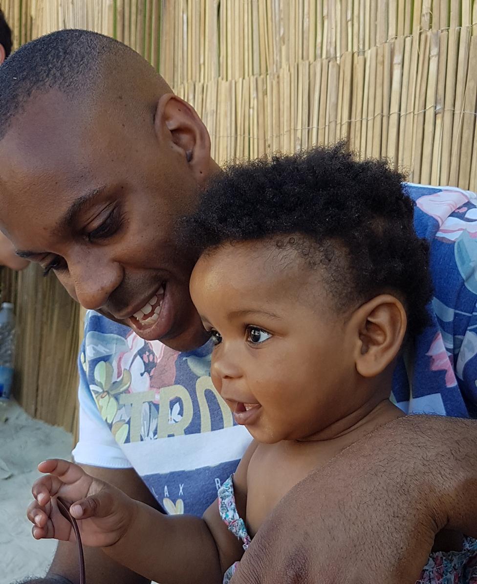 Elliott with his toddler daughter on the beach