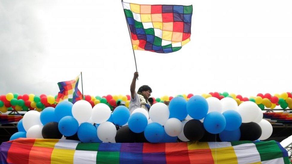 Former Bolivian President Evo Morales waves a flag during a rally with supporters after returning to the country, in Chimore, Bolivia November 11, 2020.