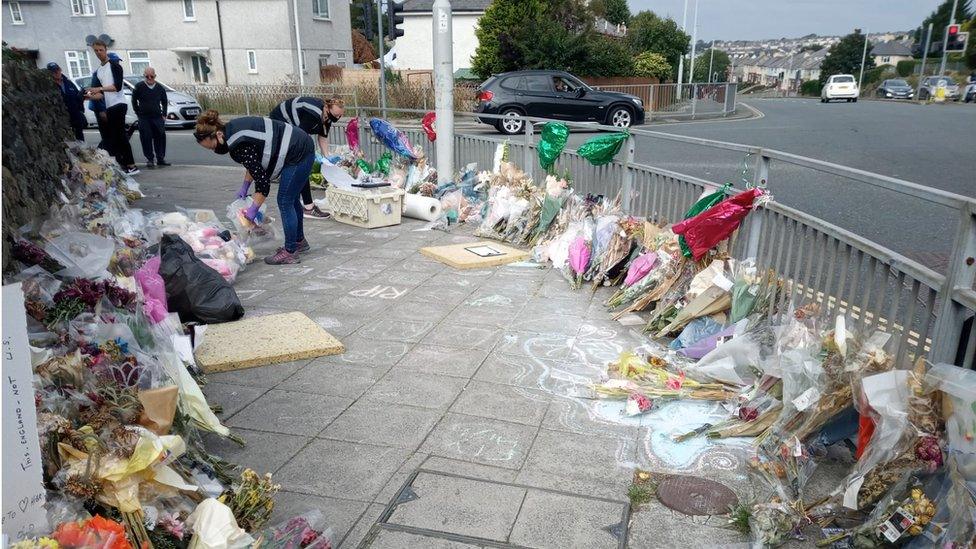 Workers move the tributes