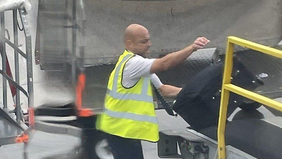 Co-pilot loading luggage