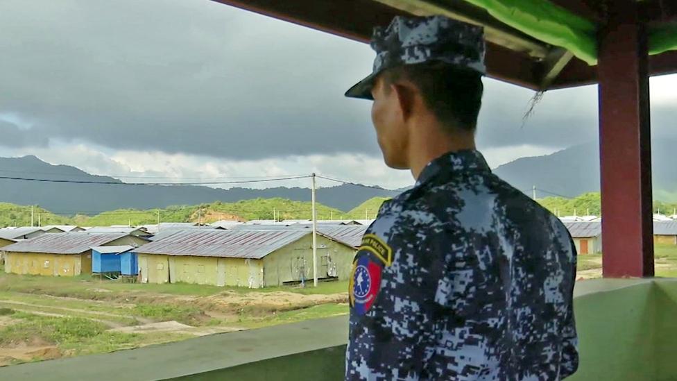 A soldier looks out over the new camp