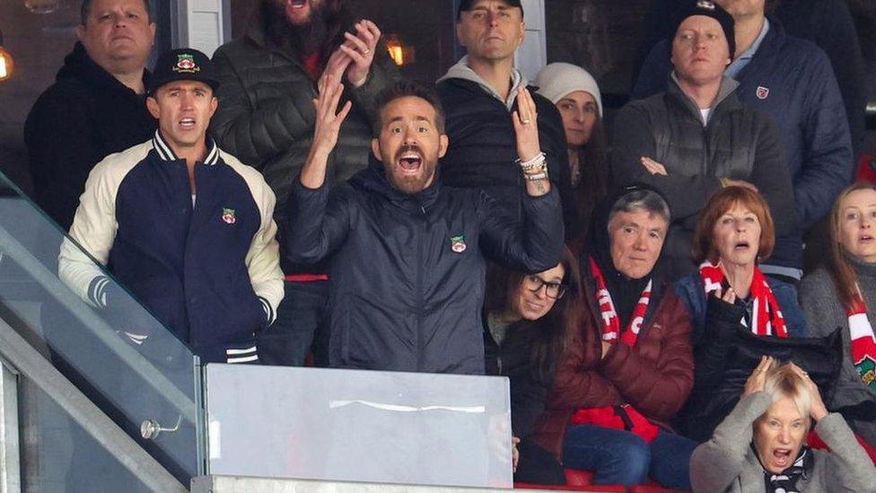 Rob McElhenney and Ryan Reynolds with other fans at Wrexham