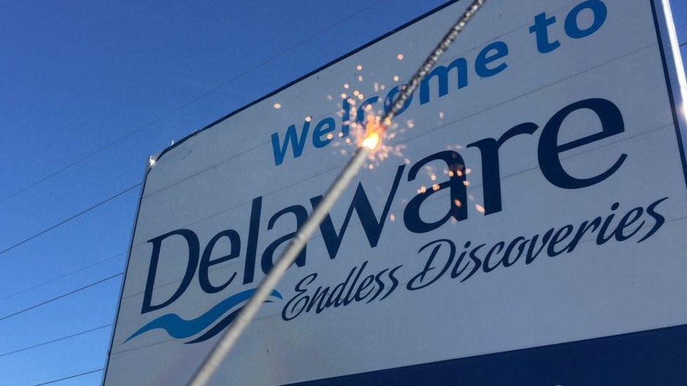 Welcome to Delaware sign with sparkler in front