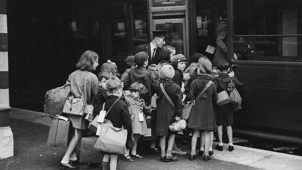 Children carrying bags and suitcases board a train, which will take them out of wartime London to the safety of the countryside. In view of developments in the Second World War and the beginning of enemy bombing in London, a decision has been made to evacuate 120,000 schoolchildren to Cornwall, Devon, Somerset and Wales. (Photo by David Savill/Getty Images)