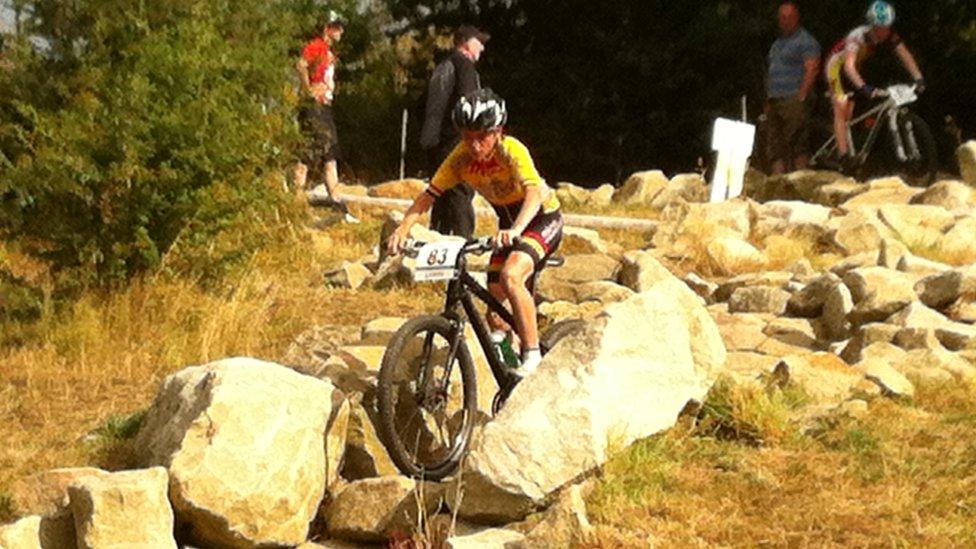 Young Tom Pidcock on his bike in competition