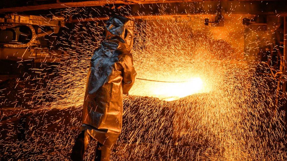 Sparks fly as a worker produces matte nickel at the PT Vale nickel plant, in Sorowako, South Sulawesi, Indonesia