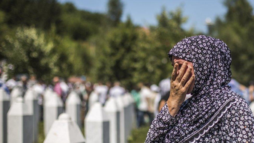 A woman mourns after the mass funeral for 136 newly-identified victims of the 1995 Srebrenica massacre attended by tens of thousands of mourners during the 20th anniversary of the massacre at the Potocari cemetery and memorial on 11 July 2015 in Srebrenica, Bosnia and Herzegovina