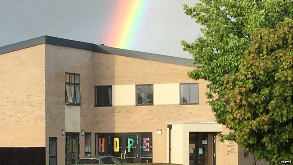 Rainbow above building displaying hope sign in Wickford, in Essex