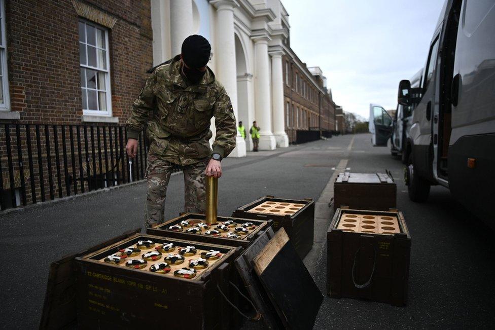 Members of the King's Troop Royal Horse Artillery place empty shells into boxes in advance of firing a 41-round gun salute at Woolwich Barracks in London.