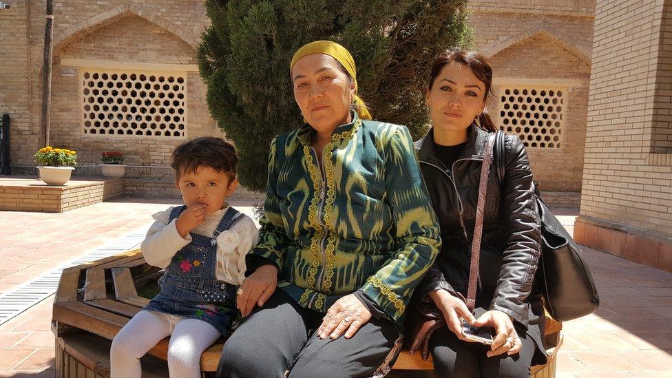 Dilrabo and her daughter and granddaughter relaxing after praying at the Daniyar shrine