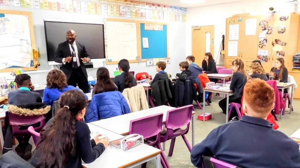 Festus Akinbusoye talking to school pupils