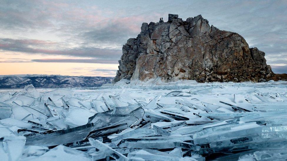 Huge rock surrounded by blocks of ice