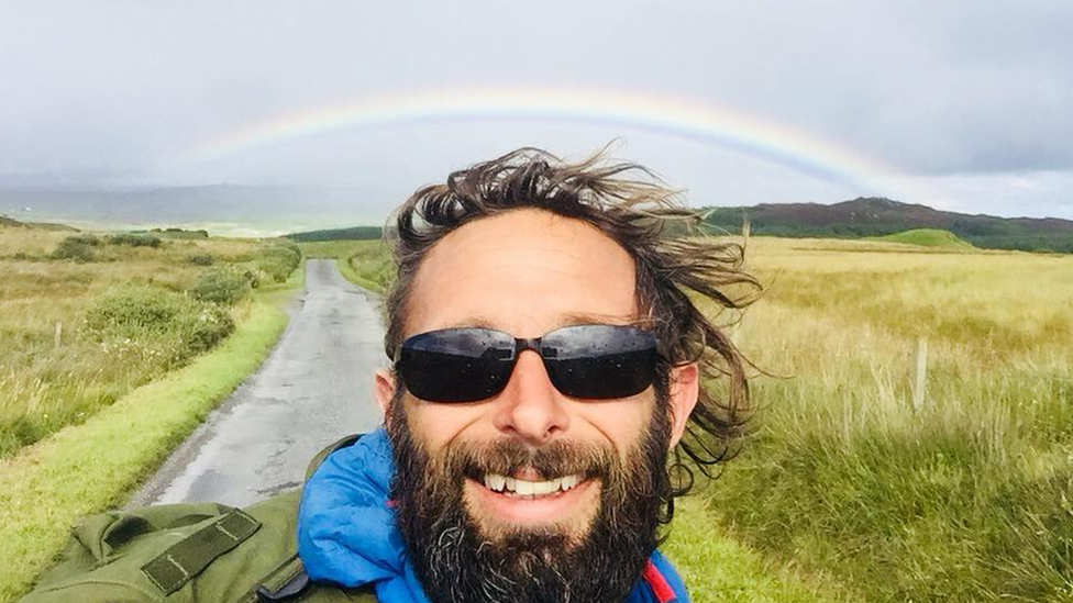 Chris with a rainbow behind him