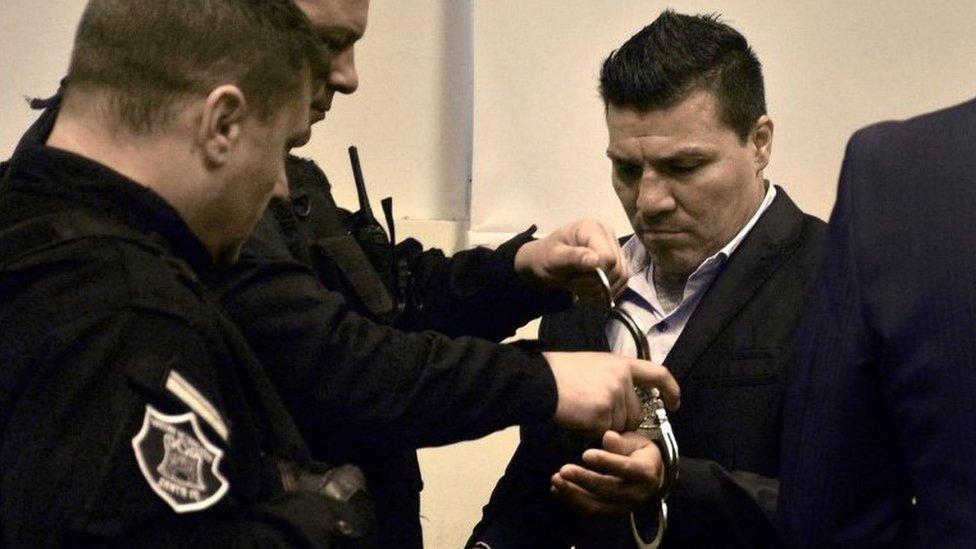 In this handout photo released by Telam, Argentine former boxer Carlos Baldomir (R) have his handcuffs removed at a court in Santa Fe, Argentina on July 31, 201