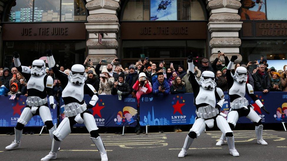 People dressed as stormtroopers from Star Wars dancing